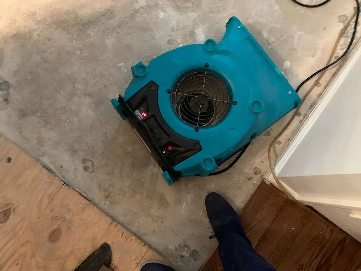 Air mover drying subfloor during Commercial Water Damage Restoration in Robbinsville